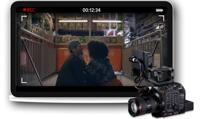 monitor with a frame from Love Story movie of two people sitting on stairs looking into each other's eyes